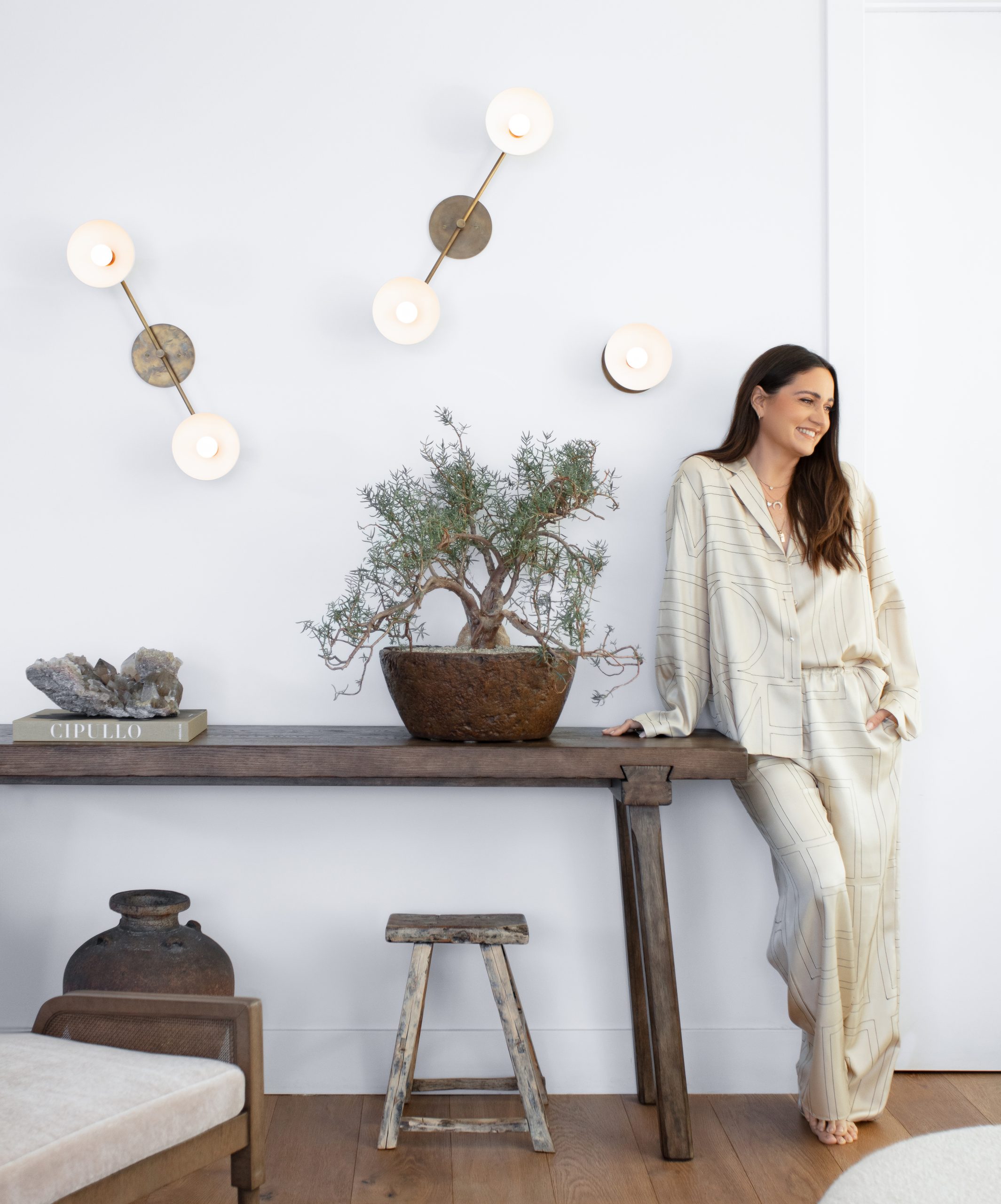 Mariel Haen standing near indoor plants by Inner Gardens