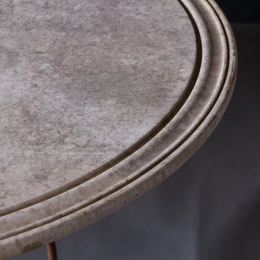 Closeup of right edge of vintage French stone table with iron base