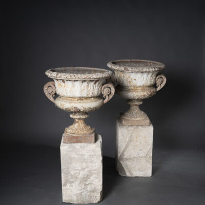 Pair of Cast Iron Urns on Stone Plinths