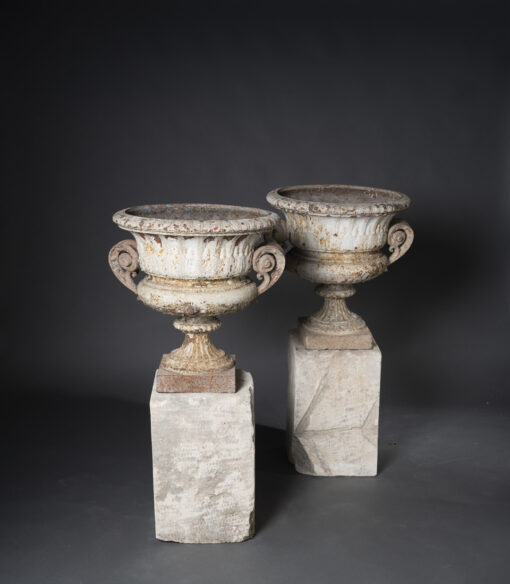 Pair of Cast Iron Urns on Stone Plinths